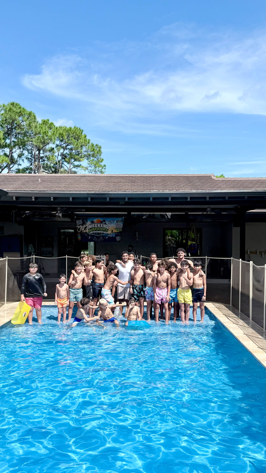 Group of Weekend Warriors posing together in the pool